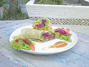 vegan Mexican Wrap: red Cabbage, green Lettuce, red Rice, Pineapple, Tomato and fresh Corn with homemade spicy mexican Sauce at Deanna Day Spa in Seminyak