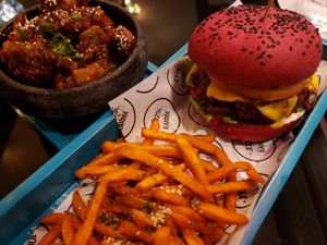 Karma Burger with sweet potatoes fries. Tempura Broccoli in the bowl. at Karma in Panama City