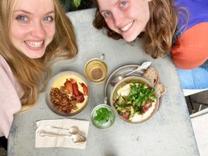 Hummus bowl (not gluten free bread) + sweet potato carrot smoothie bowl with seasonal vanilla nectarine compote and granola + herbal teas. at ÆNDRÈ in Hamburg