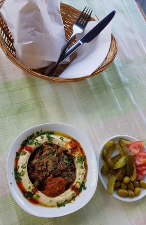 Hummus with mushrooms, pickles and pita bread at Akkawy in Berlin