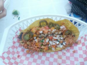 Enchilada with toppings at Tacos Ne in Merida