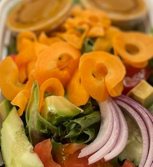 House Salad with avo, cucumbers, tomatoes and peanut dressing. at Simply Thai in Louisville