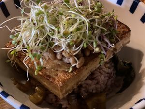 Tofu steak with natto topping, rice with Korean veggie pickles under.  at Diner Jackie 다이너재키 in Seoul