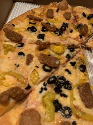 Vegan cheese, vegan sausage, b. peps, and blk olives. Dang at Pizzeria 1081 & Bakery in Akron