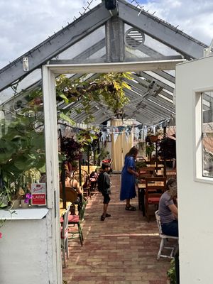 Sitting area in the greenhouse   at Slottsträdgårdens Kafé in Malmo