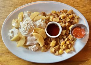 Pancakes with apple and crispy breakfast potatoes.  at Life on Mars in Seattle