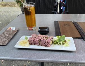 Inside out sushi with pink rice, tempeh and mango and some apple juice  at Tiger Club Vegan Sushi in Berlin