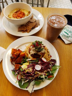Tahini burger on brown rice, hummus in background and vanilla-cacao smoothie to the right! at Kupfert & Kim - Yorkville in Toronto