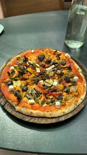 Tasty vegan Pizza on the menu. They also sell smoothies, Pasta and vegan banana bread.  at The Old House  in Karnataka