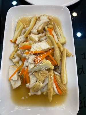 a corn, carrot and tofu dish with savory juicey sauce at Vegan Center Cafe in Vientiane