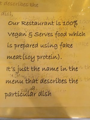 Vegan sign on every table  at Vegan Center Cafe in Vientiane