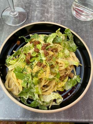 Vegan Carbonara topped with ceasar salad  at Don Vegan in Quebec