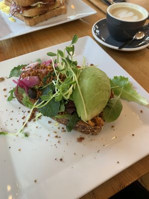 Avocado toast and cappuccino with oat milk  at The Breakfast Club - Sloterdijk in Amsterdam