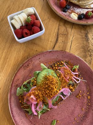 This is the avocado toast with the little bowl of fruit   at The Breakfast Club - Sloterdijk in Amsterdam