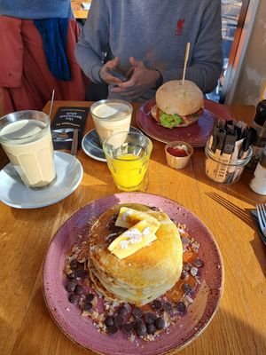 Vegan banana pancakes, orange juice, latte (macchiato) with oat milk and avocado breakfast burger at The Breakfast Club - Sloterdijk in Amsterdam