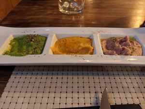 Three types of hummus - spinach, regular, and raspberry at The Black in Fuenlabrada
