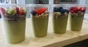 Green Bio-Matcha Mousse with kiwi, banana and almond milk, VEGAN. Topped with cereals and fresh fruit. Tasty, fresh and healthy! at Nectare 2 in Bologna