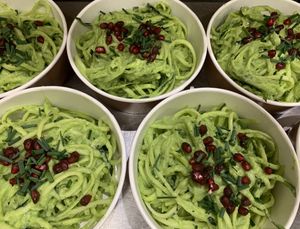 Raw spaghetti of zucchini and cucumbers with creamy sauce of avocado and cucumbers and typing of pomegranate at Nectare 2 in Bologna