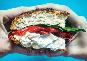 Focaccia di Aurora - Artisan Focaccia with house-made vegan cream cheese, roasted red pepper and baby spinach at Em. Vegan Sweets & Salty - Delivery Only in Lima