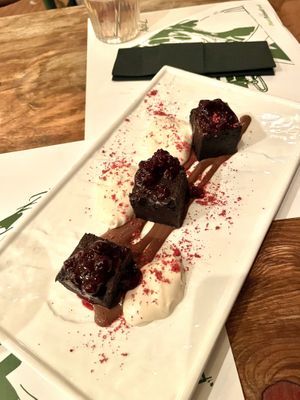 Chocolate fudge brownie with wildberry sauce and cream - dessert.  at Pandora Greenbox in Split