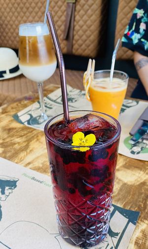 Iced latte with oat milk, orange ginger juice, and hibiscus wild berry iced tea  at Pandora Greenbox in Split