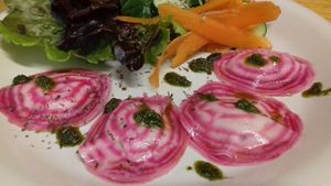 Our Beetroot RAWioli! Filled with a smooth almondcheese, served with pesto from our garden and salad. at Crulinària in La Bisbal Demporda