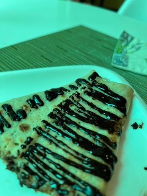 Blinchick with banana and chocolate. Feel powder or smth.. not natural.. but still gonna eat it as it’s chocolate makes sense haha  at Dr Veggie in Yerevan