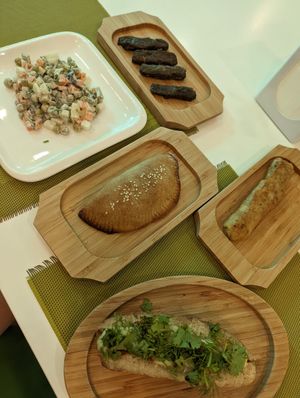 Olivier salad, vine leave dolma, empanada, blenchik, hot dog. at Dr Veggie in Yerevan