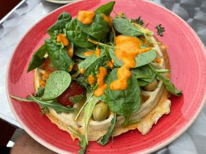 Spinach, vegan pesto, tomato and olives  at Wafflemeister in South West London
