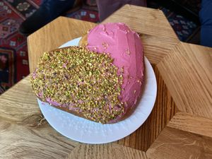 Heart-shaped bombolone with raspberry jam/jelly filling and pistache-glaze topping. Best sweet ever!  at Life's a Peach in Utrecht