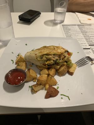 Half of the breakfast burrito. Really good and huge portion  at The Modern Vegan in San Diego