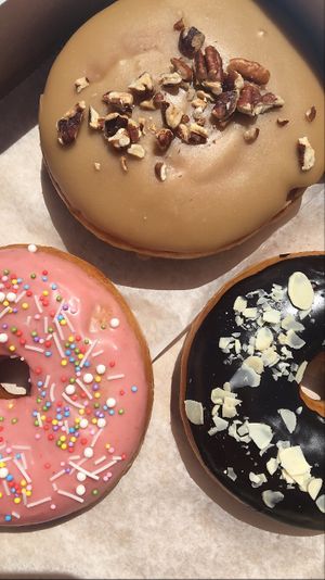 maple pecan doughnut filled with cinnamon pudding, strawberry glazed doughnut, and chocolate almond doughnut  at Peaceful Provisions in Beacon