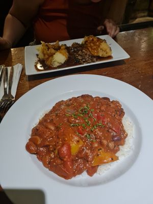 Vegan chilli and vegetarian haggis in the background at The Clachaig Inn in Ballachulish