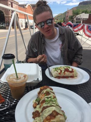 Vegan breakfast burrito smothered In their vegan green chili with a lavender oat milk latte!! My sister loved her regular burrito too! at Cafe 13 in Golden