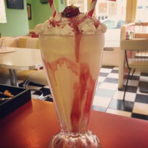 Peach & raspberry vegan milkshake.
3 scoops Local vegan peach ice cream, splash of oat milk, whizzed. Vegan whipped cream, cherry, sprinkles, paper straw. Yum. at Delphine's Diner in Aldeburgh