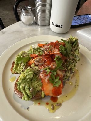Avocado toast topped with homemade kimchi  at La Masala Cafe in Barcelona