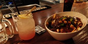 Watermelon cocktail and poutine at Bowhead Pub in Montreal