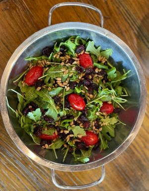 Arugula salad with sunflower seeds, craisins,  cherry tomatoes, and balsamic vinaigrette at Plant Based Mafia in Palm Beach Gardens