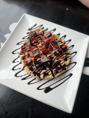 Waffle with chocolate sauce and strawberries  at Creams Cafe in Newcastle Upon Tyne