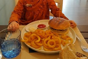 My daughters burger with fries, she ordered without fresh greens in it. at Cavo Bistrot in Cagliari