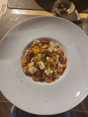 Gnocchi with red pesto, pistachio, almonds, vegan ricotta and half-dried tomatoes at Cavo Bistrot in Cagliari