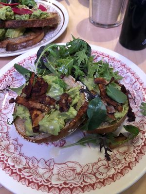 Avocado bagel with coconut facon, rocket  at Origin in Petone