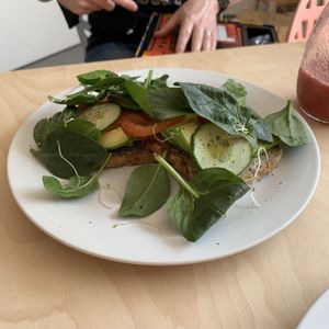 Toast with avocado, cucumber, tomato, alfalfa sprouts and spinach. at Klein Geluk Ontbijt in Heemskerk