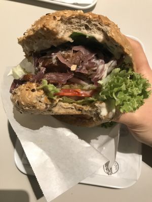 Beyond meat patty with plenty of salad and caramellized onions  at Krowarzywa in Poznan