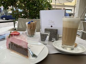 Vegan cake and latte with oat mill at Cafè Konditorei Confiserie Pöhl in Merano