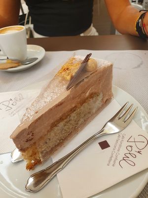 Vegan hazelnut and caramel cake and soy macchiato at Cafè Konditorei Confiserie Pöhl in Merano