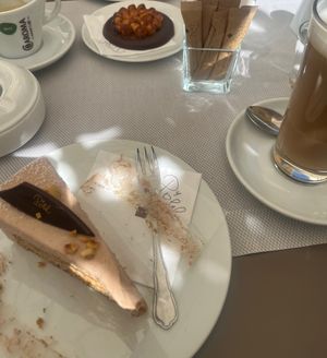 Hazelnut cake with vegan latte macchiato and another hazelnut chocolate something  at Cafè Konditorei Confiserie Pöhl in Merano