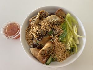 Saigon Noodle-Rice noodles, spring rolls, TVP, green onion, bean sprouts, lettuce, topped with roasted peanuts and served with a side of Aulac sauce.  at Loving Hut in Orlando
