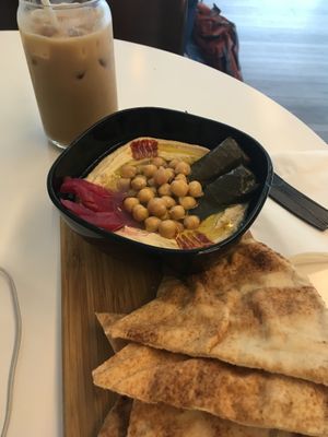 Hummus platter and iced Yemeni latte (veganized with oat milk) at Qawa Coffee Co in Middletown