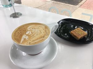 Vegan latte with oat milk and vegan pastry at Qawa Coffee Co in Middletown